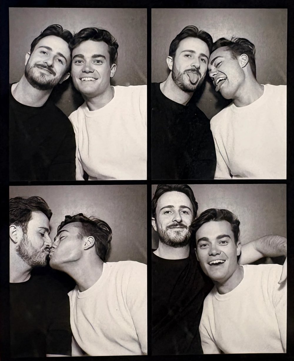 Henry and Warren in a black and white photo booth strip: smiling, pulling faces, kissing and laughing